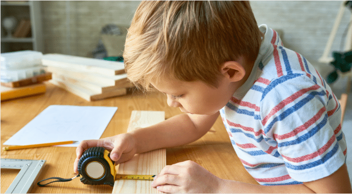Child Measuring Wood